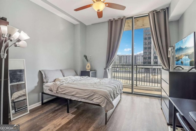 bedroom featuring ceiling fan, access to outside, expansive windows, and wood-type flooring