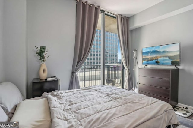 bedroom featuring a wall of windows and access to exterior