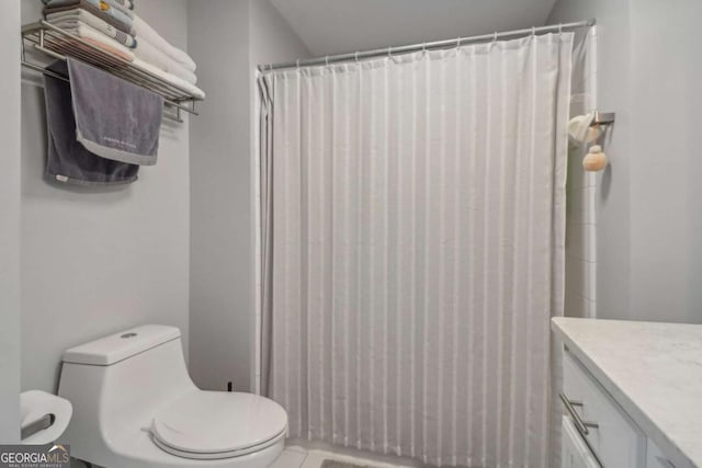 bathroom featuring vanity, curtained shower, and toilet