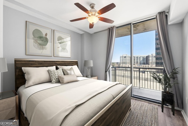 3040 Peachtree Rd NW Unit 613, Atlanta, GA 30305 - bedroom with access to exterior, wood finished floors, a wall of windows, and ceiling fan