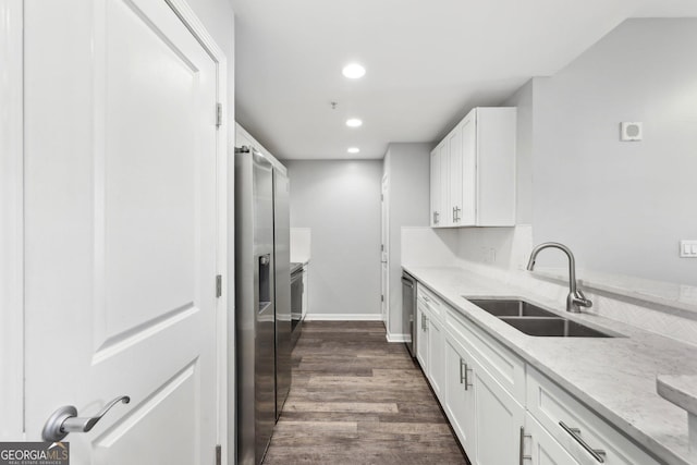 3040 Peachtree Rd NW Unit 613, Atlanta, GA 30305 - kitchen featuring stainless steel appliances, white cabinets, light stone counters, recessed lighting, and dark wood-type flooring