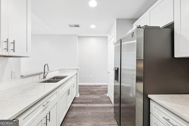 3040 Peachtree Rd NW Unit 613, Atlanta, GA 30305 - kitchen with stainless steel fridge with ice dispenser, dark wood-style flooring, white cabinetry, light stone counters, and recessed lighting
