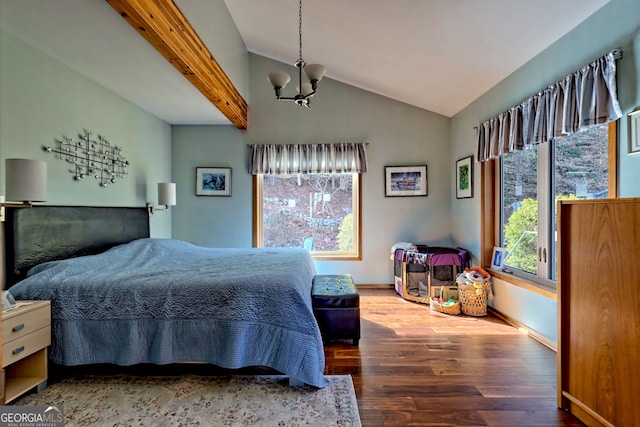 bedroom featuring an inviting chandelier, baseboards, vaulted ceiling, and wood finished floors