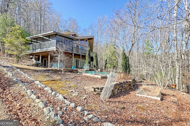 back of house with a sunroom