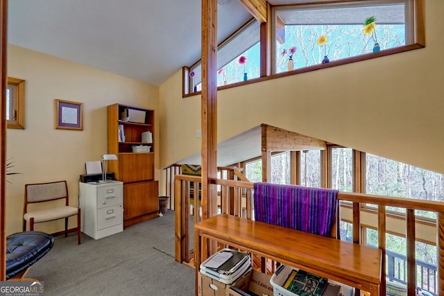 carpeted office space with lofted ceiling