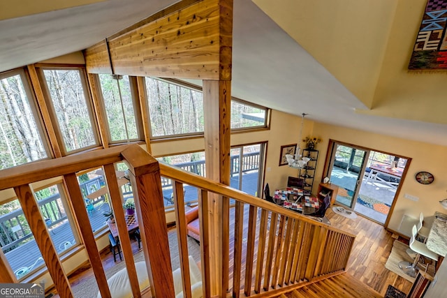 staircase featuring lofted ceiling and wood finished floors