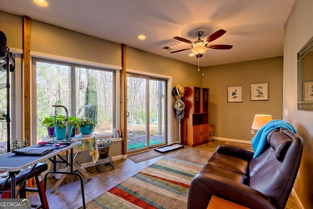 tiled living area with recessed lighting, a healthy amount of sunlight, visible vents, and baseboards