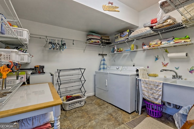 laundry area with laundry area, baseboards, and separate washer and dryer