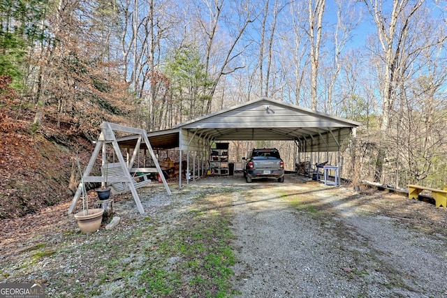 view of outbuilding with a detached carport and driveway