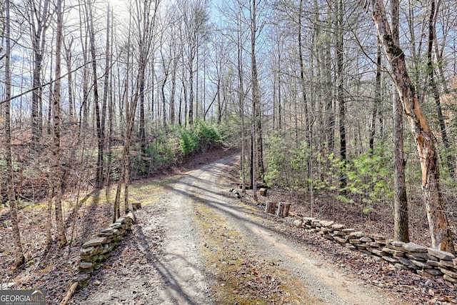 view of road featuring a forest view