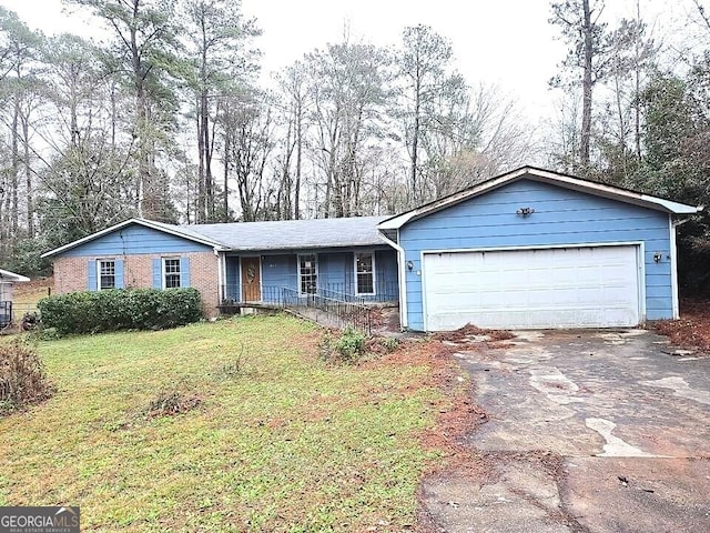 ranch-style house with a garage and a front lawn