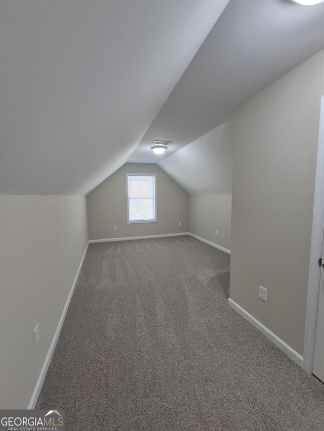 bonus room with carpet flooring, baseboards, and lofted ceiling