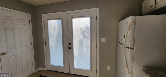 entryway with french doors and light tile patterned floors