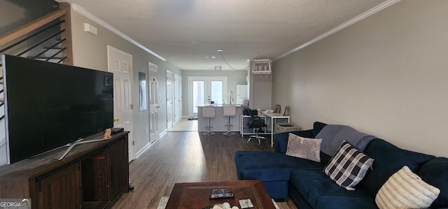 living room with crown molding, hardwood / wood-style flooring, french doors, and a textured ceiling