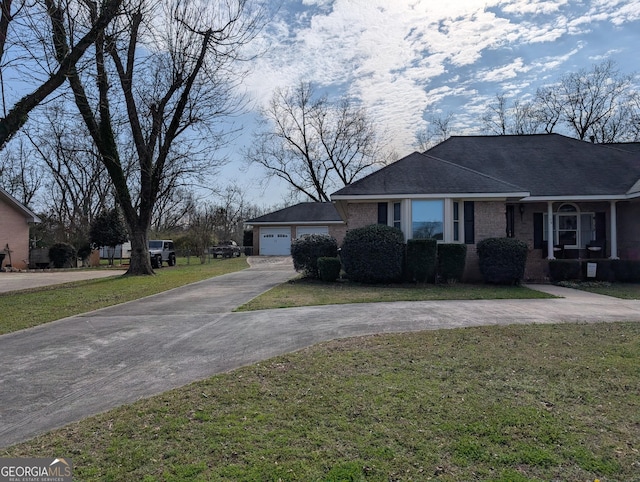 single story home featuring a front lawn and a garage