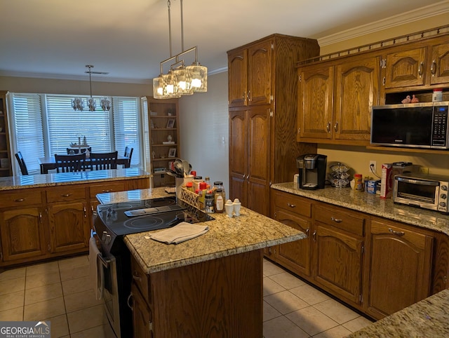 kitchen featuring a center island, decorative light fixtures, ornamental molding, range with electric cooktop, and light tile patterned flooring