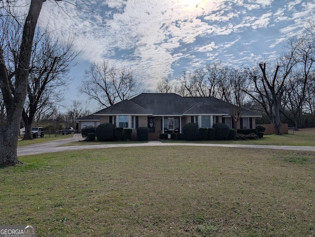 single story home featuring a front yard and a garage