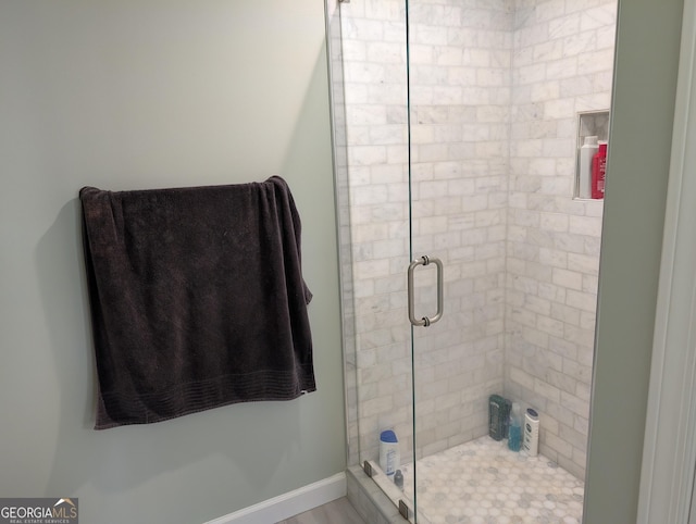 bathroom with a shower with shower door