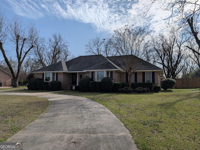 ranch-style home featuring a front yard