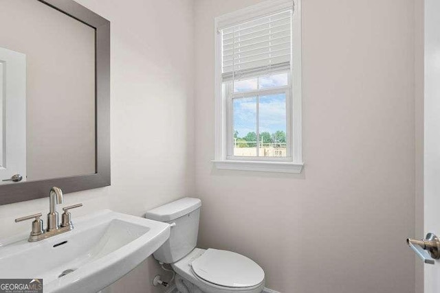 bathroom featuring toilet and sink