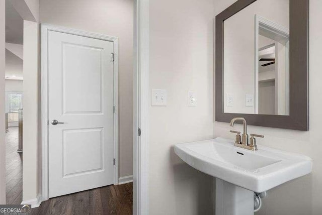 bathroom with hardwood / wood-style flooring and sink