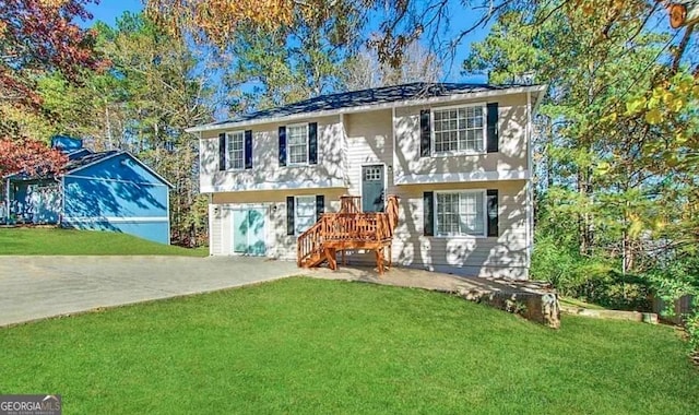 bi-level home with a garage and a front yard