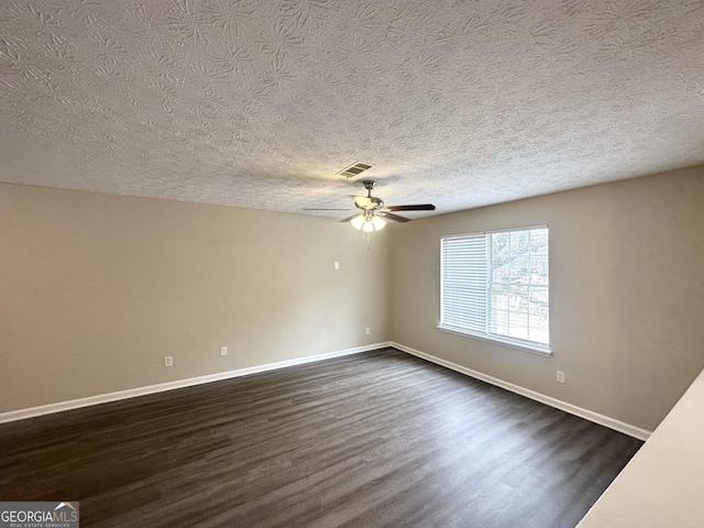 unfurnished room with ceiling fan, a textured ceiling, and dark hardwood / wood-style flooring