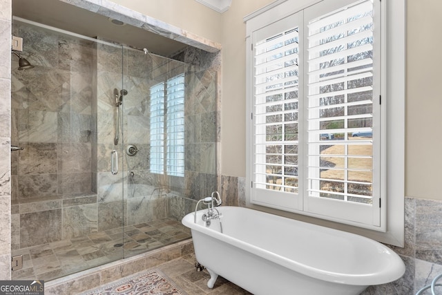 bathroom featuring plenty of natural light and shower with separate bathtub