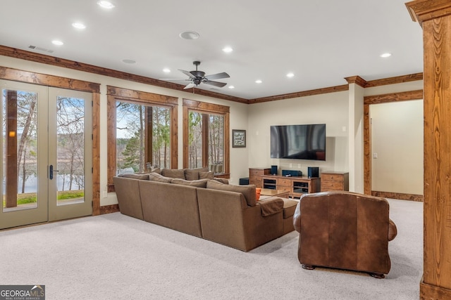 living room with ornamental molding, light colored carpet, ceiling fan, and french doors