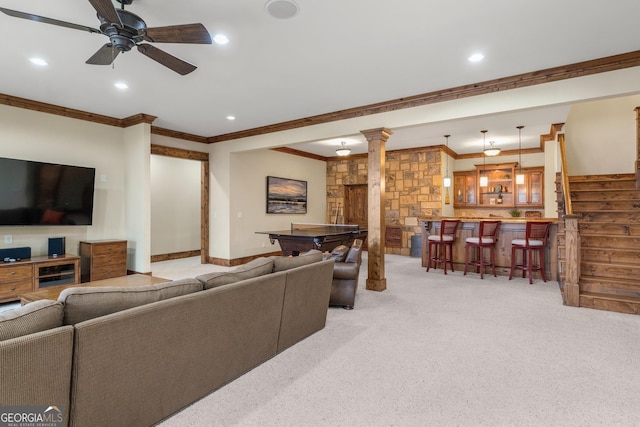 carpeted living room featuring decorative columns, ornamental molding, pool table, ceiling fan, and bar area