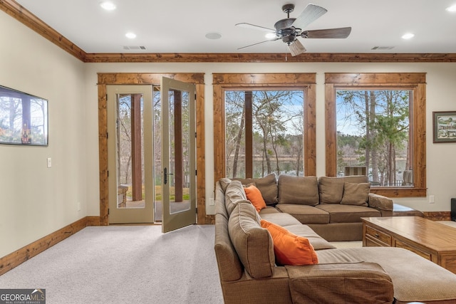 carpeted living room with ceiling fan