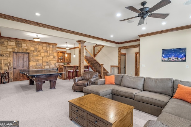 carpeted living room featuring bar, ornamental molding, and ceiling fan