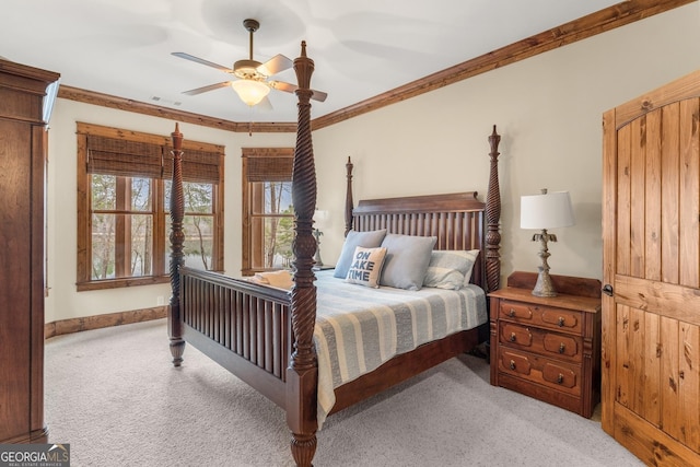 carpeted bedroom with crown molding and ceiling fan