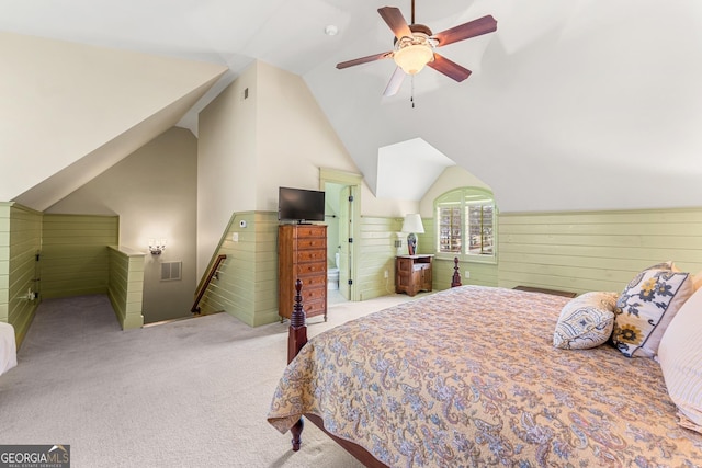 carpeted bedroom with lofted ceiling, ceiling fan, and wood walls