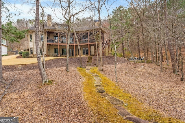 back of house featuring a deck