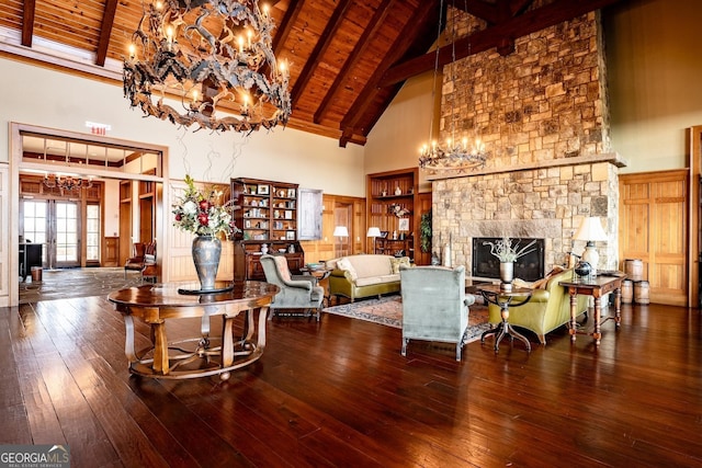 living room featuring hardwood / wood-style flooring, a stone fireplace, wooden ceiling, and high vaulted ceiling