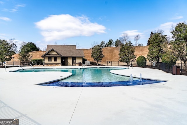 view of swimming pool with a patio and pool water feature