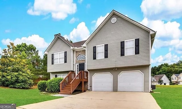 bi-level home with a garage, a front yard, and central air condition unit