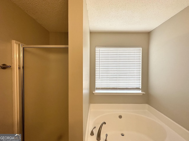 1202 Grove Trail Pass, Douglasville, GA 30134 - bathroom with a stall shower, a textured ceiling, and a garden tub