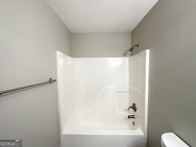 1202 Grove Trail Pass, Douglasville, GA 30134 - bathroom with a textured ceiling and shower / bathtub combination