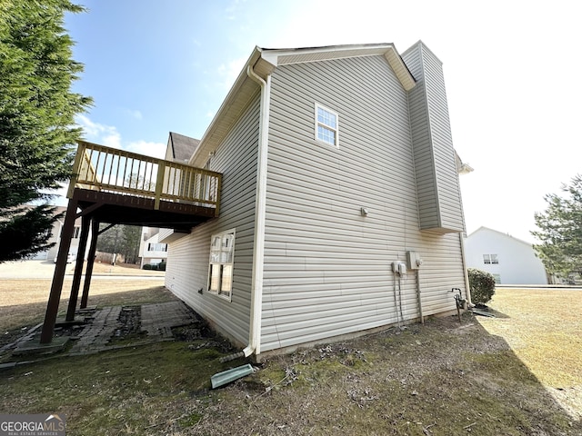 1202 Grove Trail Pass, Douglasville, GA 30134 - view of side of home with a wooden deck and a chimney