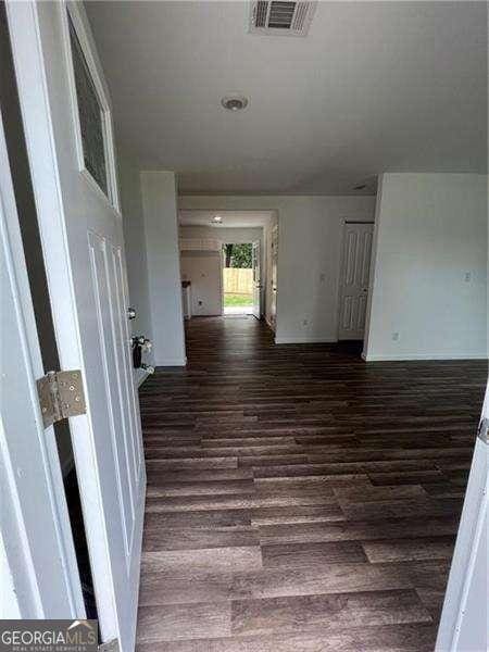 hall with dark wood-type flooring