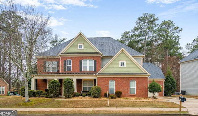 craftsman inspired home with a porch, brick siding, concrete driveway, roof with shingles, and a front lawn