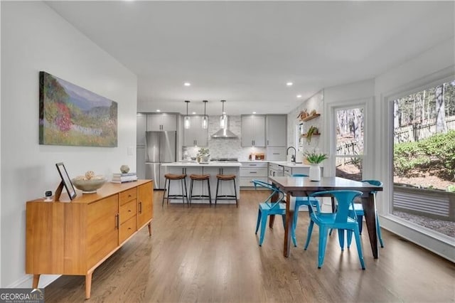 dining room featuring light wood finished floors and recessed lighting