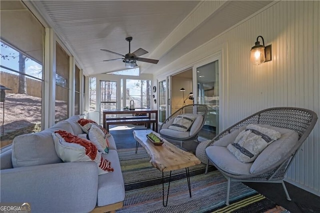 sunroom / solarium featuring a wealth of natural light, vaulted ceiling, and ceiling fan