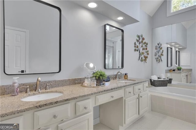 full bath featuring lofted ceiling, tile patterned flooring, a sink, and double vanity