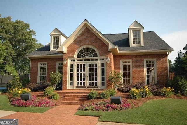 back of property with french doors and brick siding