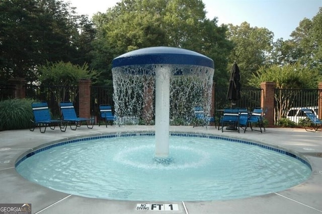 view of pool featuring a patio area and fence