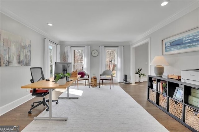 home office featuring plenty of natural light, ornamental molding, and wood finished floors