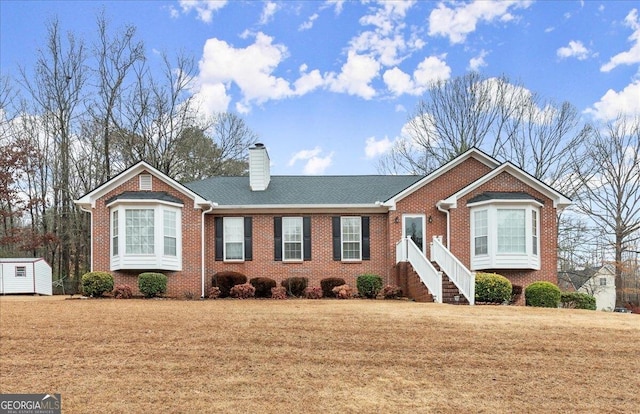 view of front facade featuring a storage shed and a front lawn